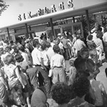 Crowds waiting in line at entrance to Six Flags Over Texas on opening day of the season