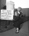 David and Lawana Ledford next to sign that reads "Hey Kids Send Letters to Santa Now!" sponsored by Arlington's City Recreation Department and Citizen-Journal,