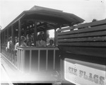 Group of visitors sitting on train at Six Flags Over Texas