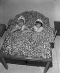 Marib Allbright, left, and Martha Denton, queens of the City Wide Easter Egg Hunt, up to their elbows in candy eggs, Arlington, Texas