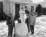 Snowman built by children in 500 block of South Elm Street, Arlington, Texas