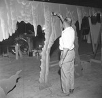 Workman painting cave at Six Flags Over Texas