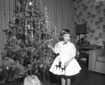 Jo Anne Bunkley decorating Christmas tree, 1953