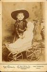 Cabinet card photograph of young Elsie Barclay with doll in a carriage by Windisch