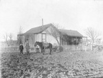 Clarence Overman with his horse and Mrs. Overman on a porch, South Colorado City, Texas