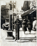 Policeman holds sign pointing to the Palace Theater on 7th Street in Fort Worth