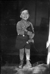 Portrait of a boy holding a cat by Basil Clemons 1887-1964