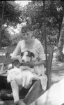 An girl holding a dog by Basil Clemons 1887-1964