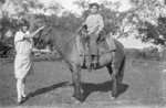 A children riding a horse with a women by Basil Clemons 1887-1964