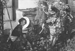 Candid picture of two women in a garden by Basil Clemons 1887-1964