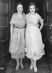 Two women wearing dresses by Basil Clemons 1887-1964