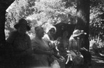 A small group sitting under the trees by Basil Clemons 1887-1964