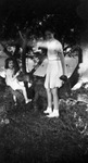 Two young girls posing with a low tree by Basil Clemons 1887-1964