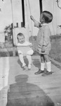 Two children on a porch by Basil Clemons 1887-1964