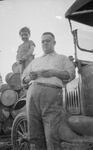 Man standing next to car by Basil Clemons 1887-1964