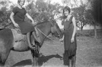 A children riding a horse with a women by Basil Clemons 1887-1964