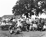 Golfers sitting under tree by Basil Clemons 1887-1964