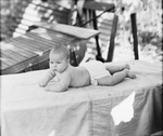 Portrait of a baby outside by Basil Clemons 1887-1964