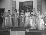 Bridesmaids and flower girls photographed with bride inside a church by Basil Clemons 1887-1964