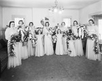 A bride with bridesmaids and flower girls by Basil Clemons 1887-1964