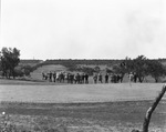 People watching a golf match in the country by Basil Clemons 1887-1964