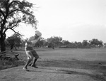 A man swinging at a golf ball by Basil Clemons 1887-1964