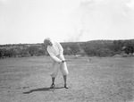 A man swinging a golf club by Basil Clemons 1887-1964