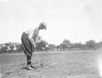 A man swinging a golf club by Basil Clemons 1887-1964