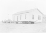 W. J. Cox moving the Spencer residence for the high school, Breckenridge, Tex. by Basil Clemons 1887-1964