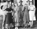 A group of smiling solders and women pose for a photograph by Basil Clemons 1887-1964