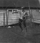 A cowboy twirling a rope by Basil Clemons 1887-1964