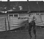 A cowboy performs with a lasso by Basil Clemons 1887-1964