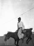 A cowboy rides a bucking bronco by Basil Clemons 1887-1964