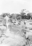 Two young children hold a fishing net, possibly at Big Sandy Creek near Breckenridge, Texas. by Basil Clemons 1887-1964