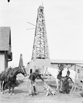 Two cowboys stand over an animal, perhaps a wolf or a coyote by Basil Clemons 1887-1964