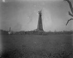 An oil derrick with oil spewing from the top by Basil Clemons 1887-1964