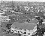 Aerial view of a town and oil derricks by Basil Clemons 1887-1964