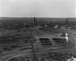 A small town with oil derricks scattered throughout by Basil Clemons 1887-1964