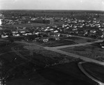 A small town with oil derricks scattered throughout by Basil Clemons 1887-1964