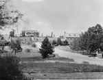 A driveway leading to two large two story brick houses by Basil Clemons 1887-1964