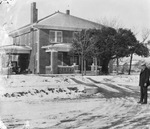 A large two story house with snow on the lawn by Basil Clemons 1887-1964