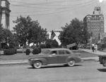 A car driving on a street in Breckenridge, Texas by Basil Clemons 1887-1964