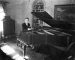 A male pianist at a piano by Basil Clemons 1887-1964