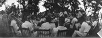 An orchestra performing for a group of people by Basil Clemons 1887-1964