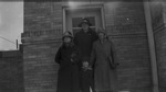 A family standing outside by Basil Clemons 1887-1964