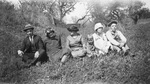 A family sitting in nature by Basil Clemons 1887-1964