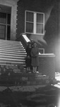 A family standing on steps by Basil Clemons 1887-1964