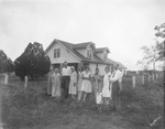 A family leaning against a fence by Basil Clemons 1887-1964