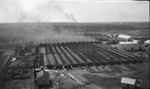 Smokes from fires cover buildings by Basil Clemons 1887-1964