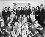 A large group of people, possibly a family reunion, pose for an indoors photograph by Basil Clemons 1887-1964